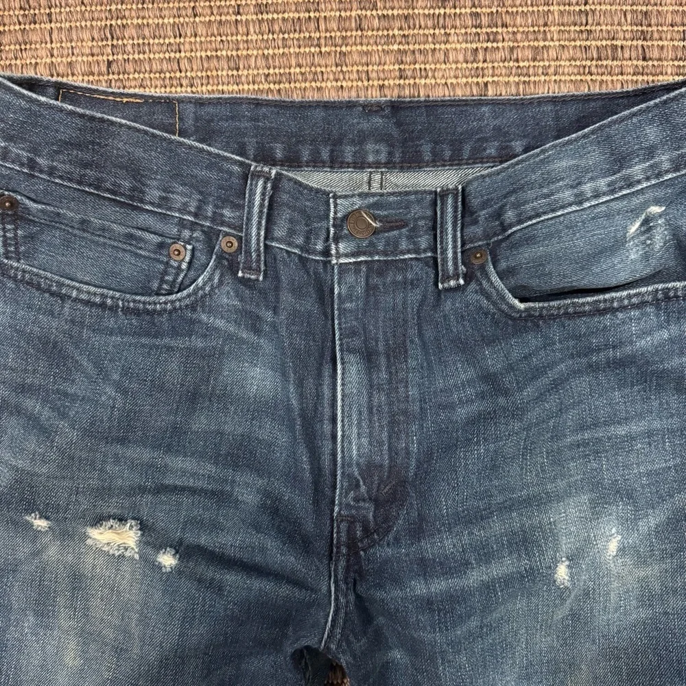 Levi's Men's 514 Straight Jeans in Medium Blue with Distressing